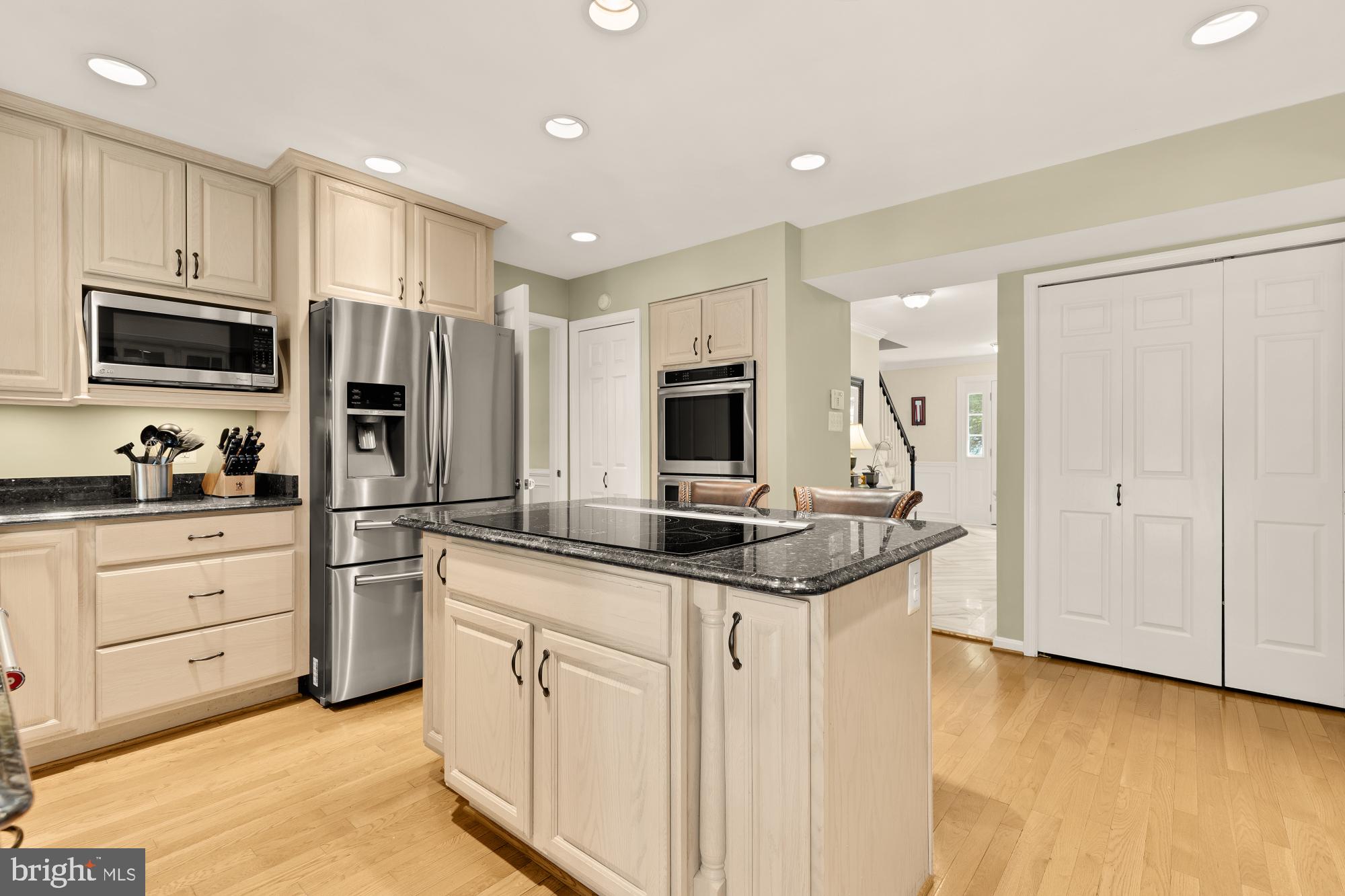 5117 Pheasant Ridge Road Fairfax, VA 22030 - Photo 14 of 59 a kitchen with granite countertop a sink and stainless steel appliances