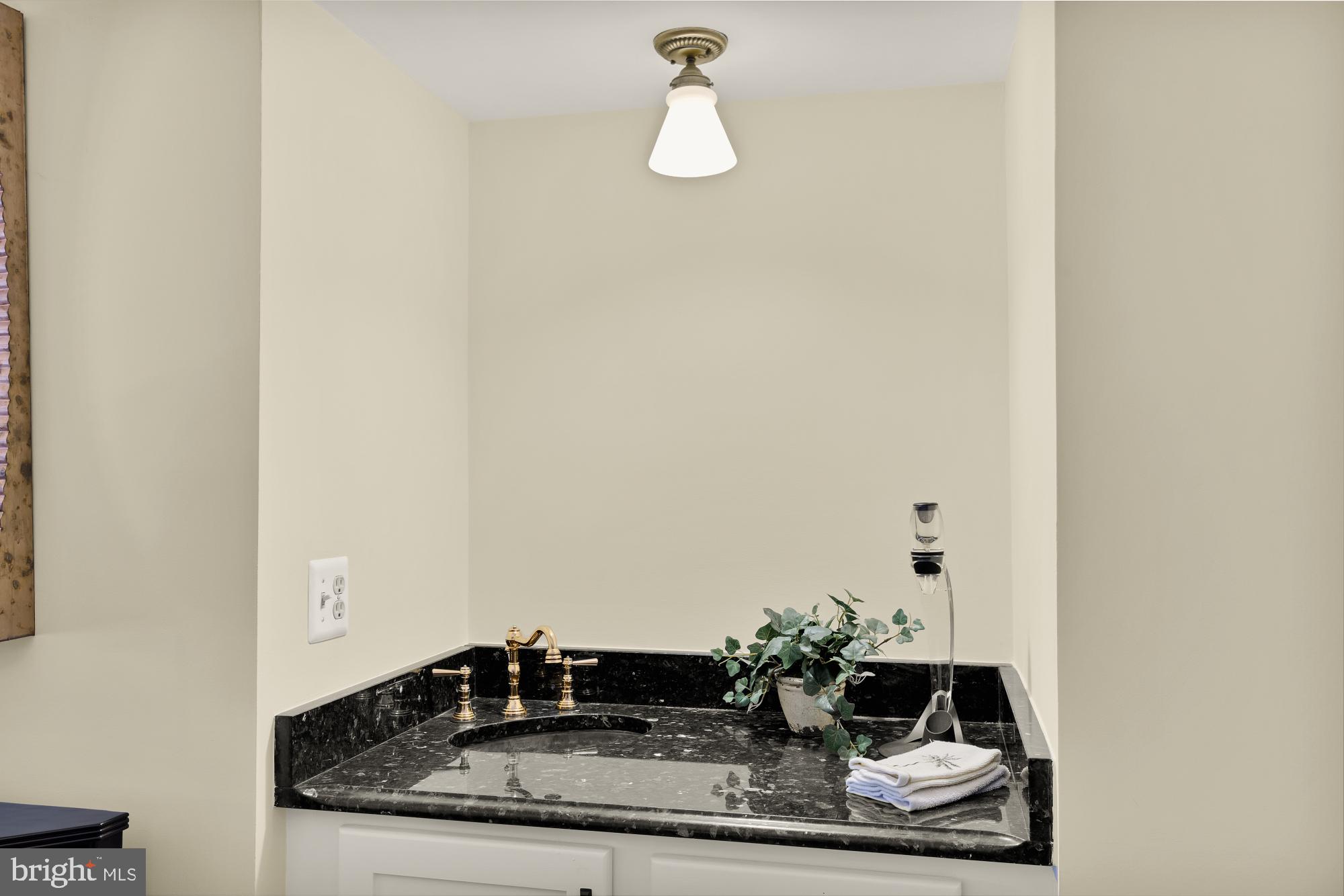 5117 Pheasant Ridge Road Fairfax, VA 22030 - Photo 19 of 59 a bathroom with a granite countertop sink and mirror