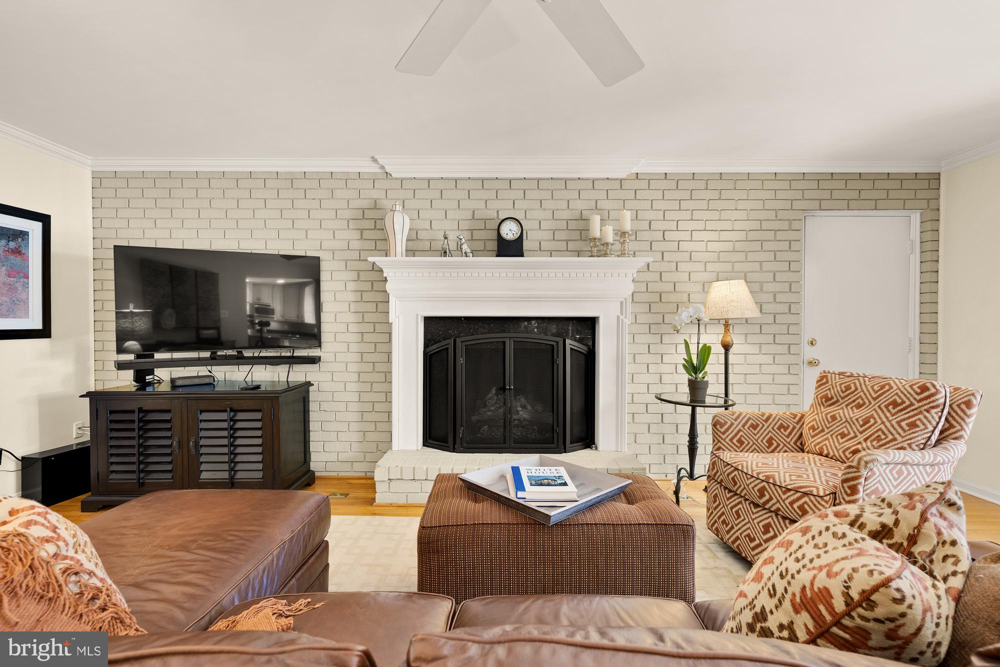 5117 Pheasant Ridge Road Fairfax, VA 22030 - Photo 20 of 59 a living room with furniture a flat screen tv and a fireplace