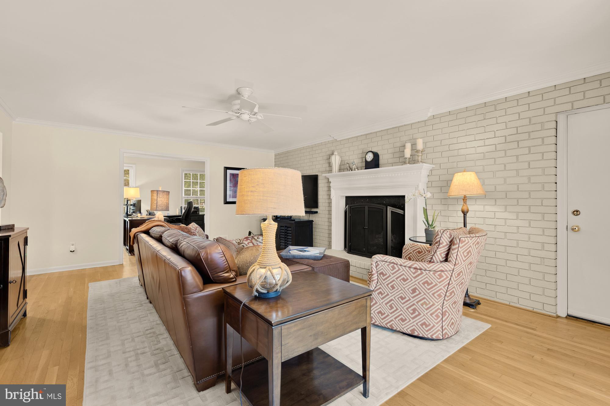 5117 Pheasant Ridge Road Fairfax, VA 22030 - Photo 22 of 59 a living room with furniture a fireplace and a table
