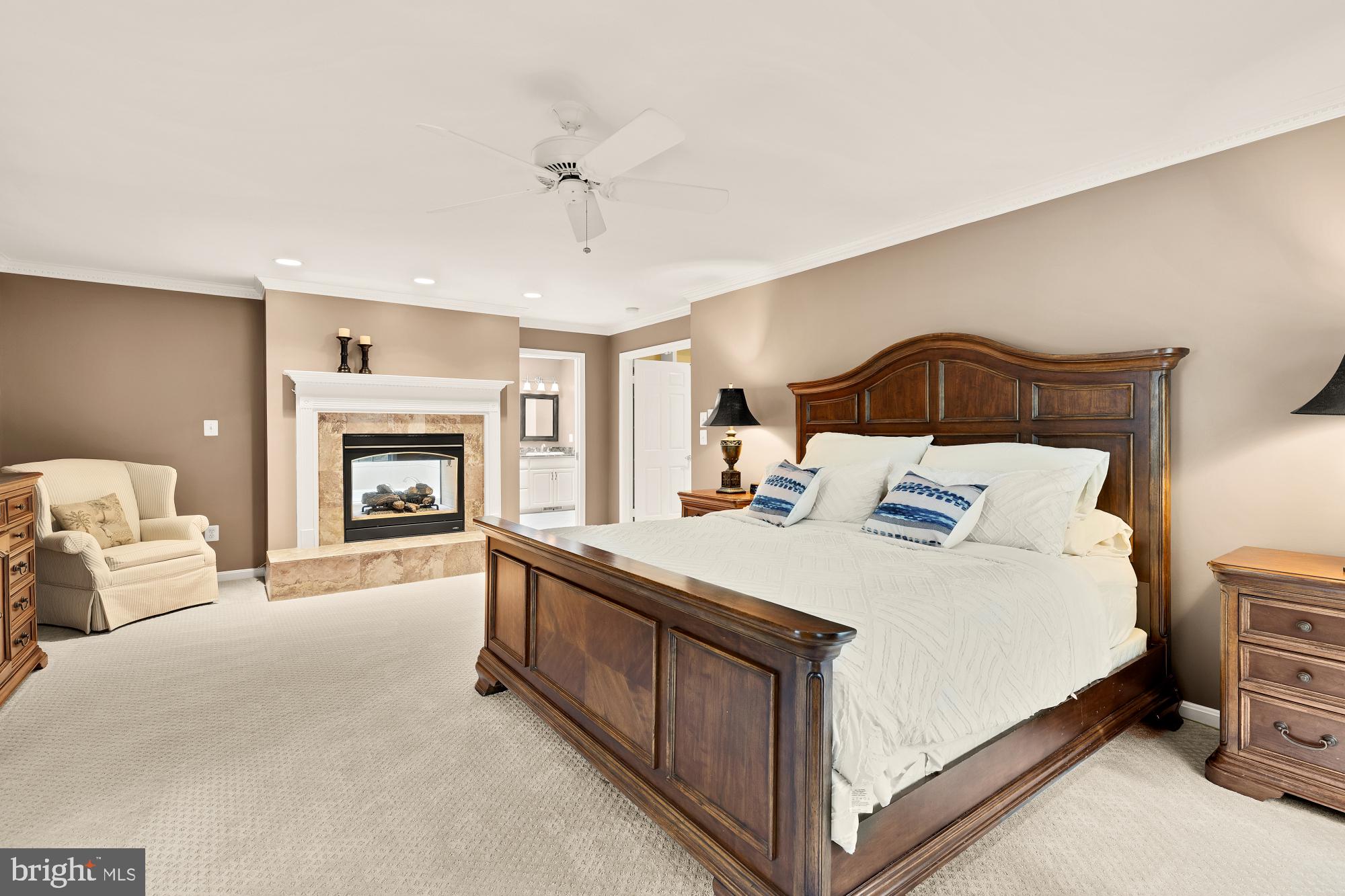 5117 Pheasant Ridge Road Fairfax, VA 22030 - Photo 28 of 59 a spacious bedroom with a bed and a fireplace