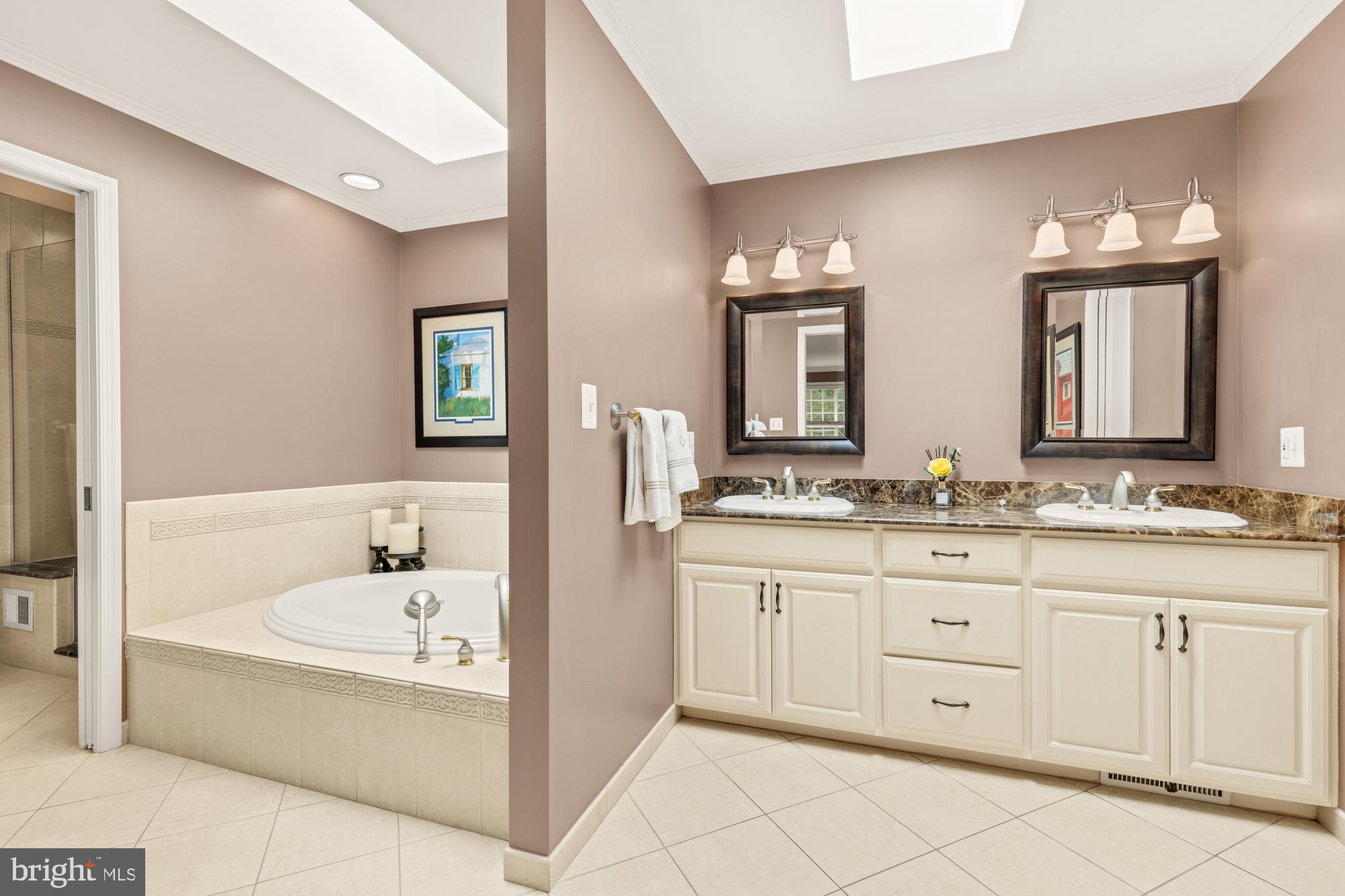 5117 Pheasant Ridge Road Fairfax, VA 22030 - Photo 32 of 59 a bathroom with a tub a double vanity sink and mirror