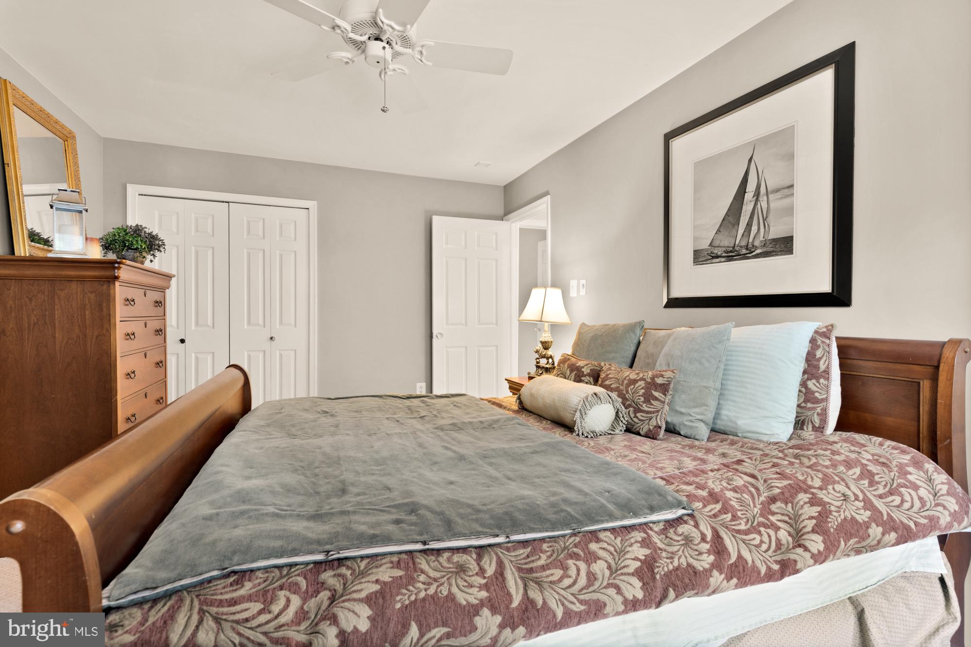 5117 Pheasant Ridge Road Fairfax, VA 22030 - Photo 42 of 59 a bedroom with a bed and a chandelier