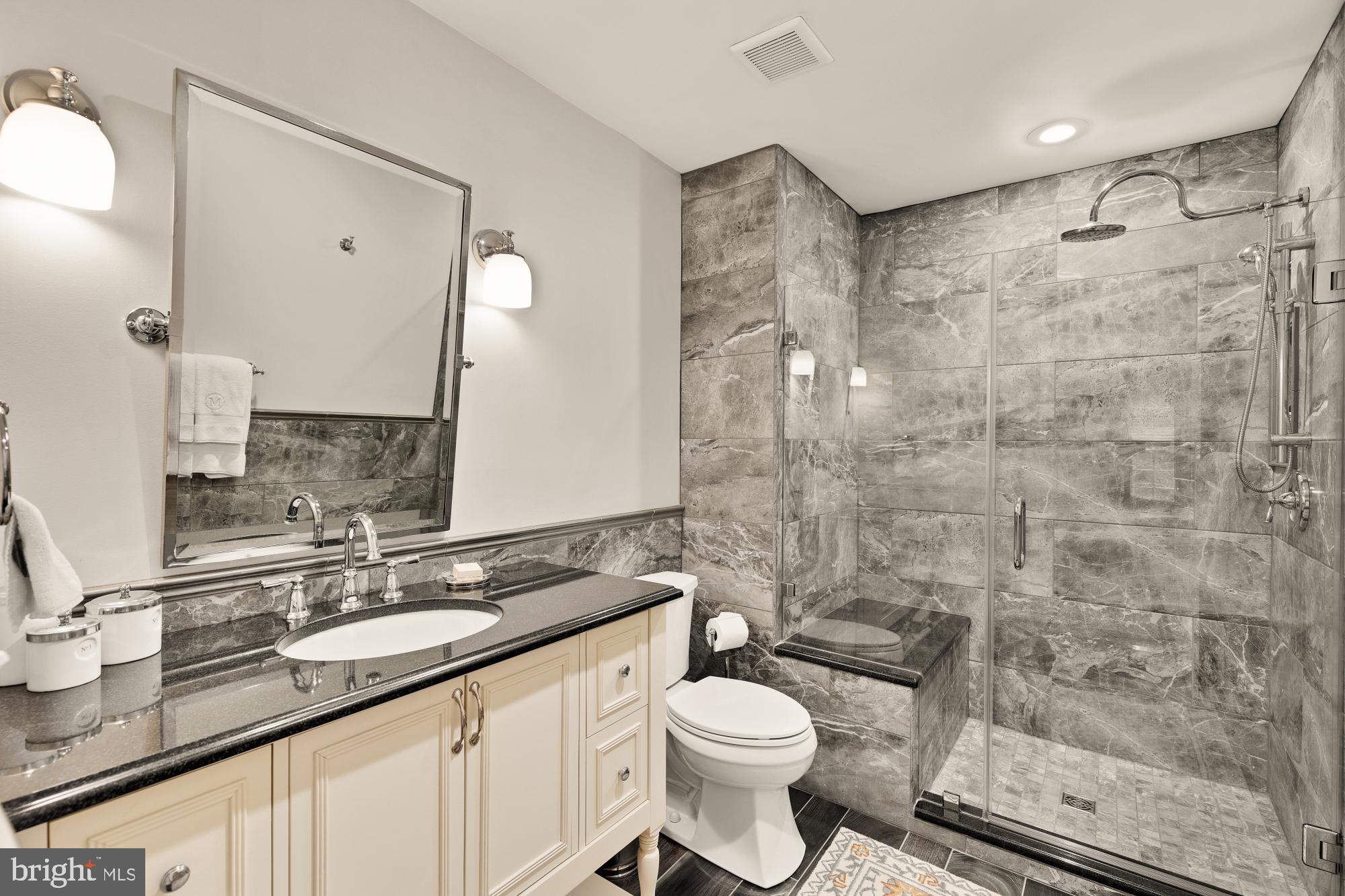 5117 Pheasant Ridge Road Fairfax, VA 22030 - Photo 43 of 59 a bathroom with a granite countertop sink toilet and shower