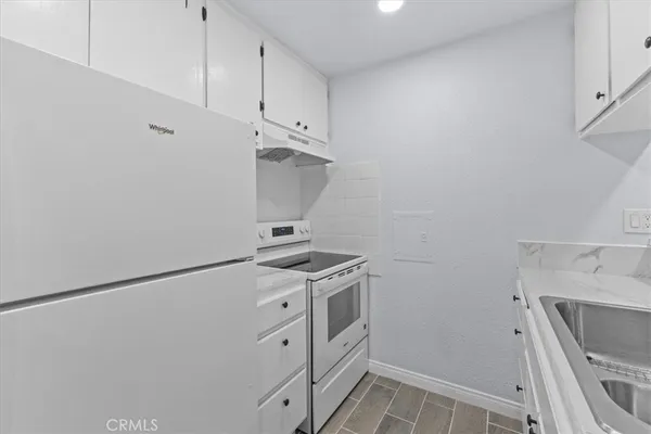 a kitchen with a stove and a refrigerator