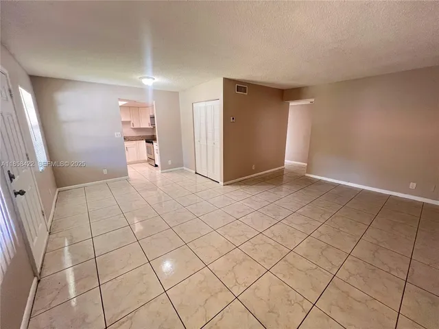 a view of an empty room and utility room