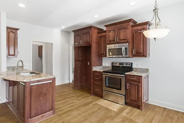 a kitchen with stainless steel appliances granite countertop a stove and a sink