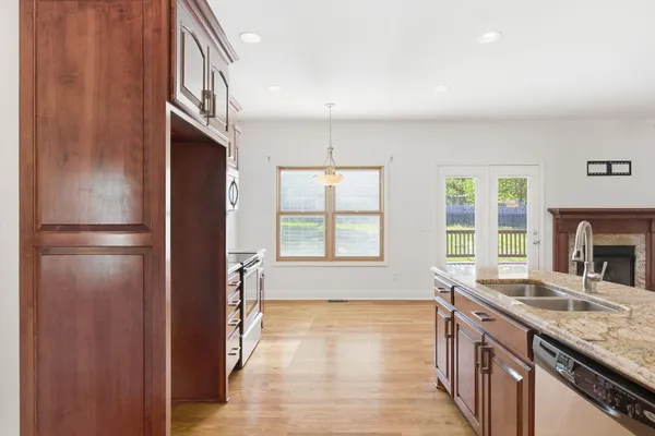 a kitchen with stainless steel appliances granite countertop a refrigerator and a sink