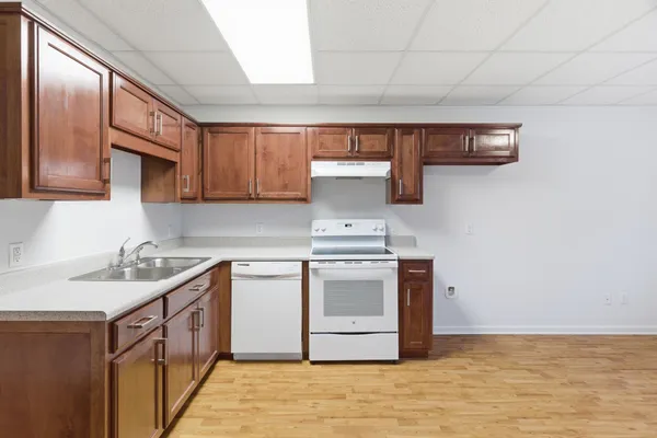 a kitchen with stainless steel appliances granite countertop a sink and cabinets