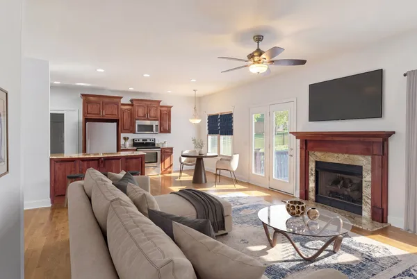 a living room with furniture a fireplace and a flat screen tv