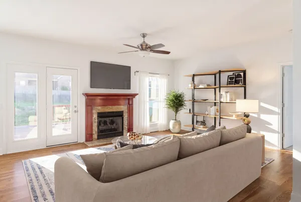 a living room with furniture a fireplace and a flat screen tv