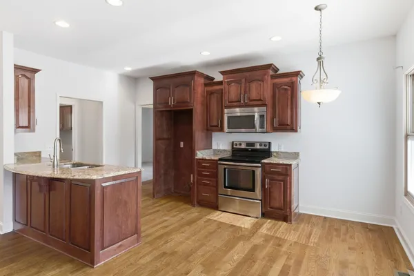a kitchen with stainless steel appliances granite countertop a stove and a sink