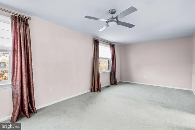 an empty room with windows and closet