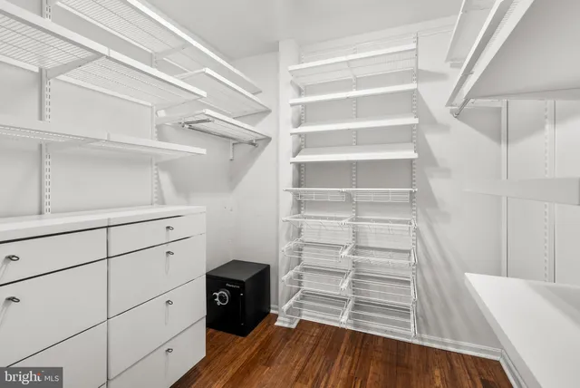 a view of walk in closet with empty racks