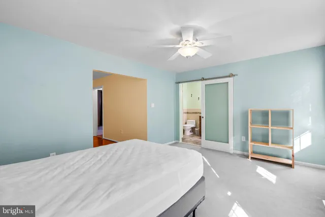 a bedroom with a large bed and a chandelier