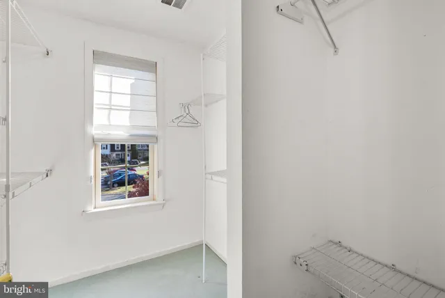 a bathroom with a window and a shower