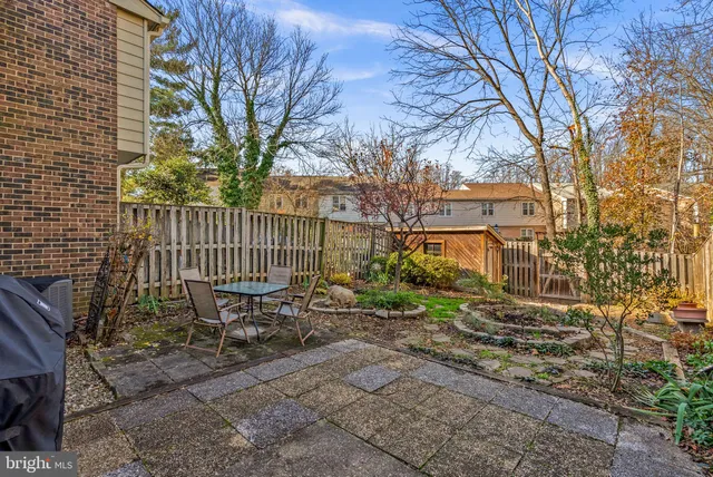 a view of a bench in the backyard