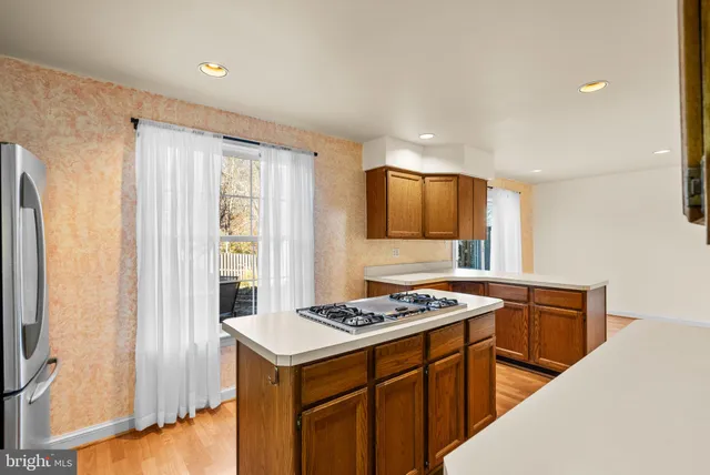 a kitchen that has a sink a stove and a refrigerator