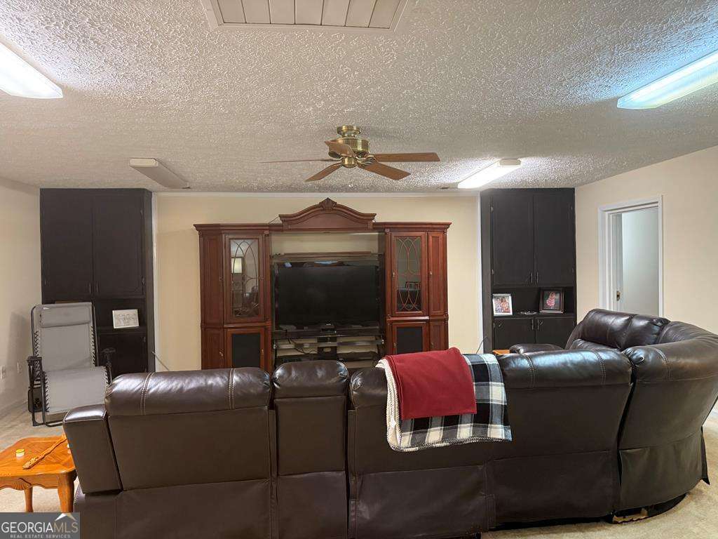 1837 Whooping Creek Road Carrollton, GA 30116 - Photo 7 of 19 a living room with furniture and a flat screen tv