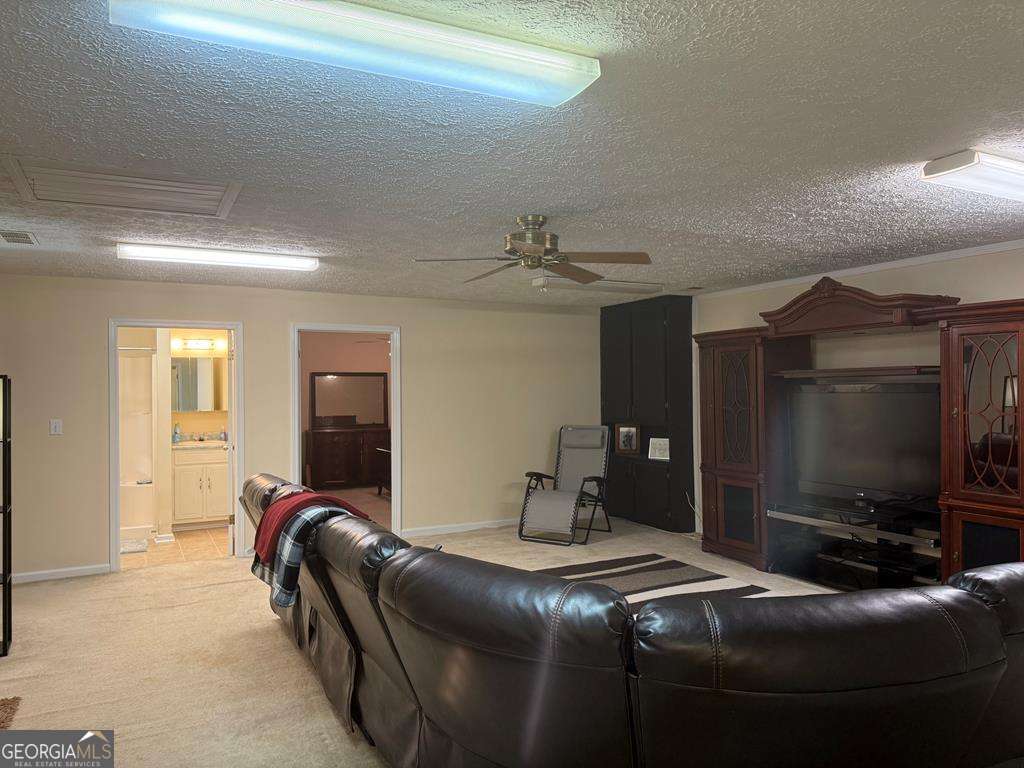 1837 Whooping Creek Road Carrollton, GA 30116 - Photo 8 of 19 a living room with furniture and a flat screen tv