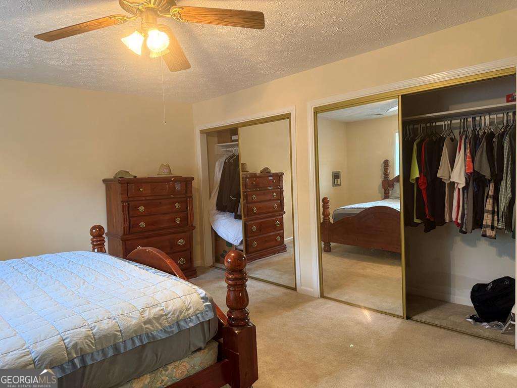 1837 Whooping Creek Road Carrollton, GA 30116 - Photo 10 of 19 a bedroom with a bed and a cabinets