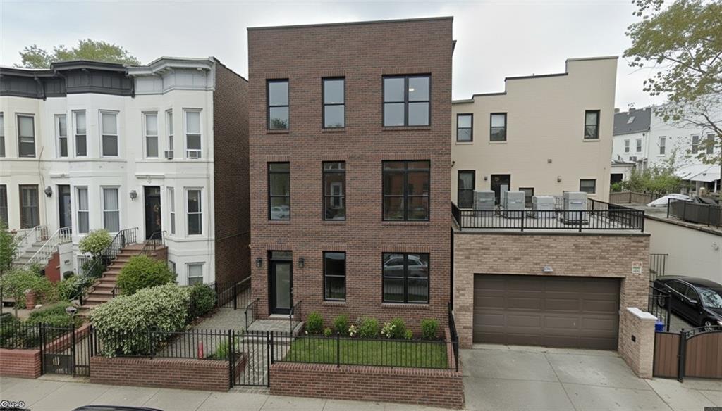 a front view of a building with garden