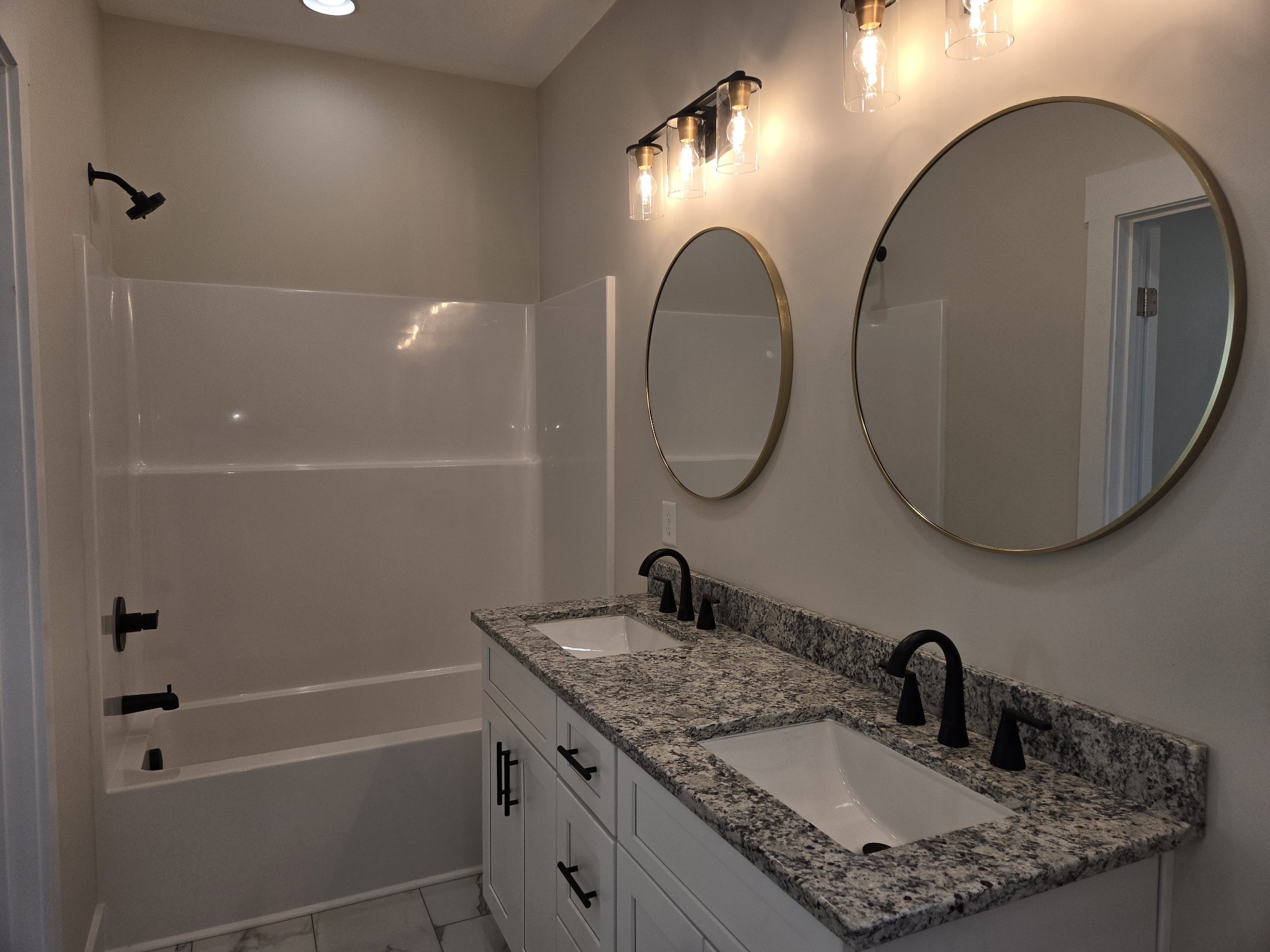 6006 Valley Road Springfield, TN 37172 - Photo 11 of 33 a bathroom with a granite countertop sink a mirror and a shower