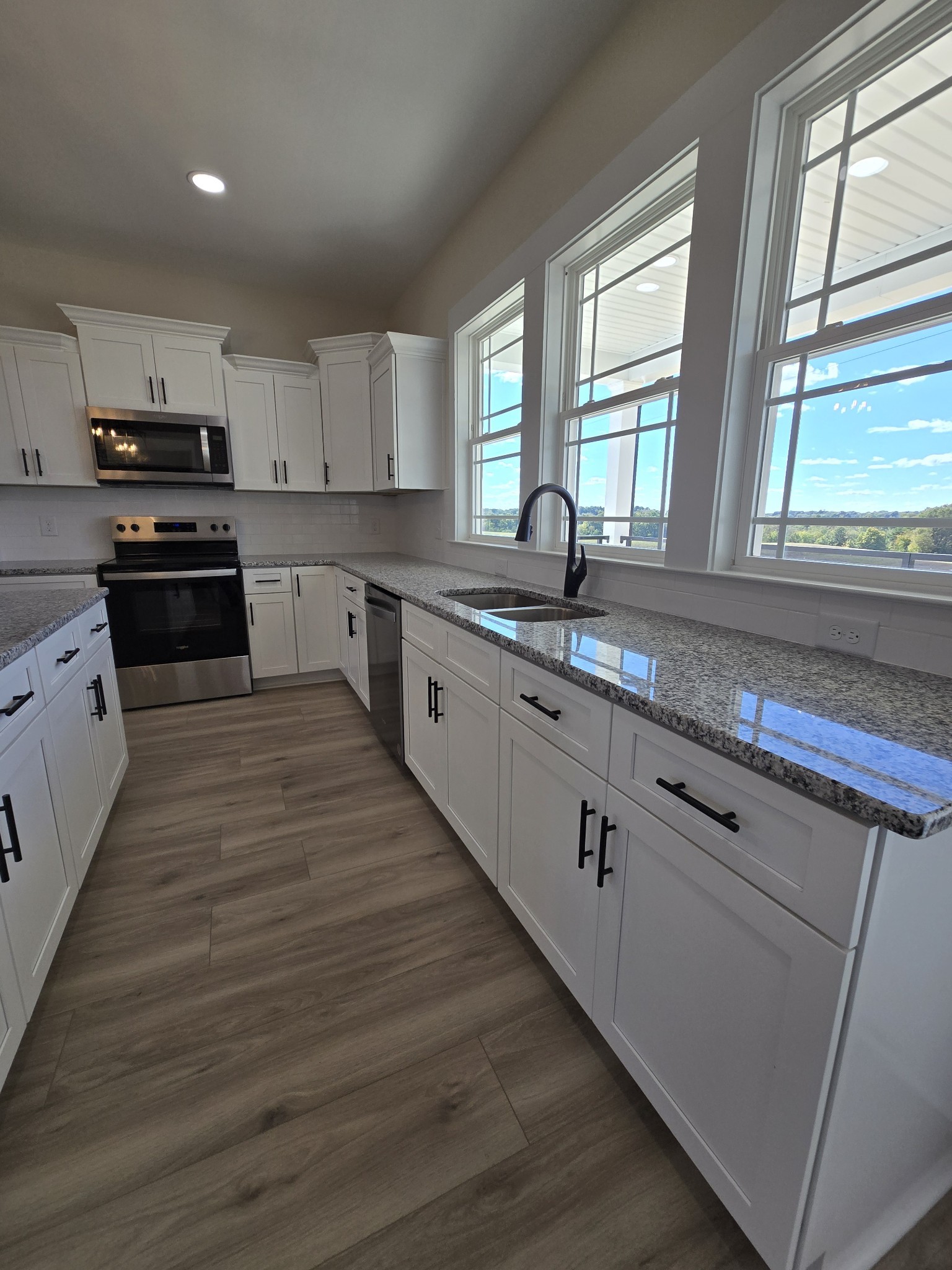 6006 Valley Road Springfield, TN 37172 - Photo 8 of 33 a kitchen with granite countertop wooden floors appliances a sink and cabinets