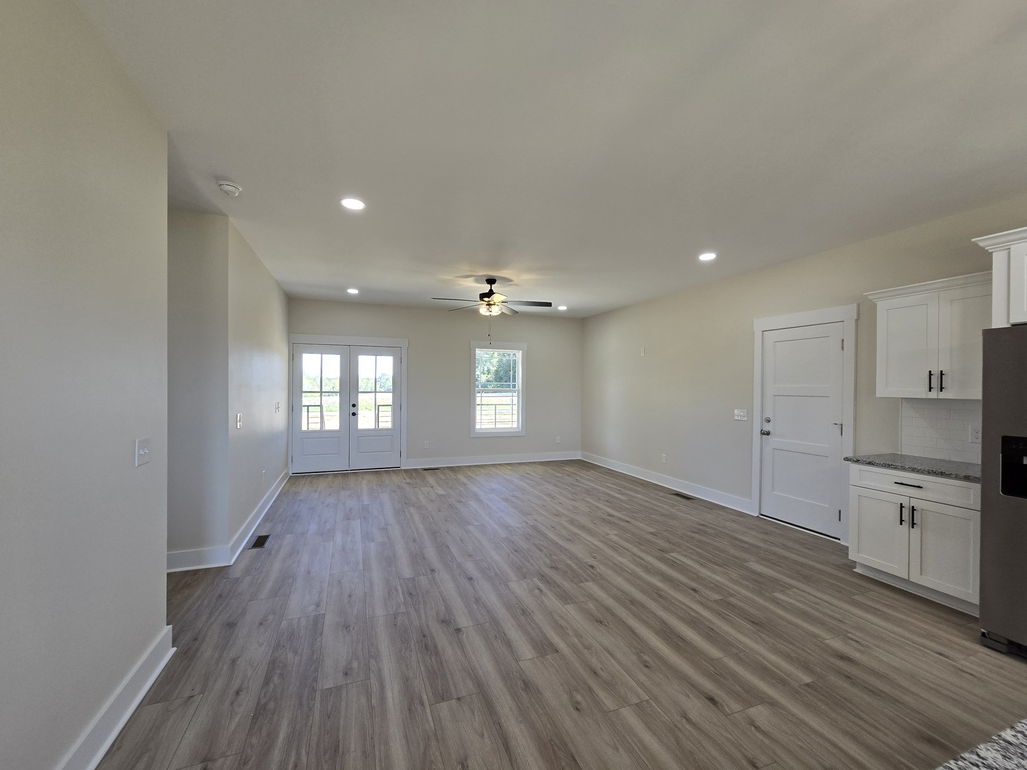 6006 Valley Road Springfield, TN 37172 - Photo 9 of 33 an empty room with wooden floor and windows