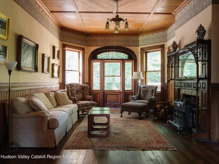 a living room with furniture and floor to ceiling windows