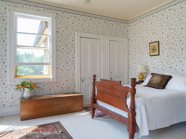 a bedroom with furniture and a window