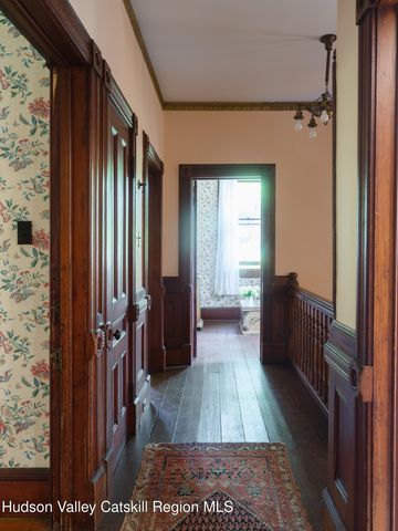 a view of hallway with furniture and a window
