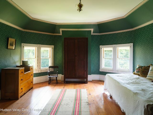a living room with furniture and large windows