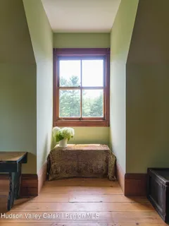 a bed sitting in a bedroom next to a window