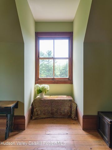a bed sitting in a bedroom next to a window