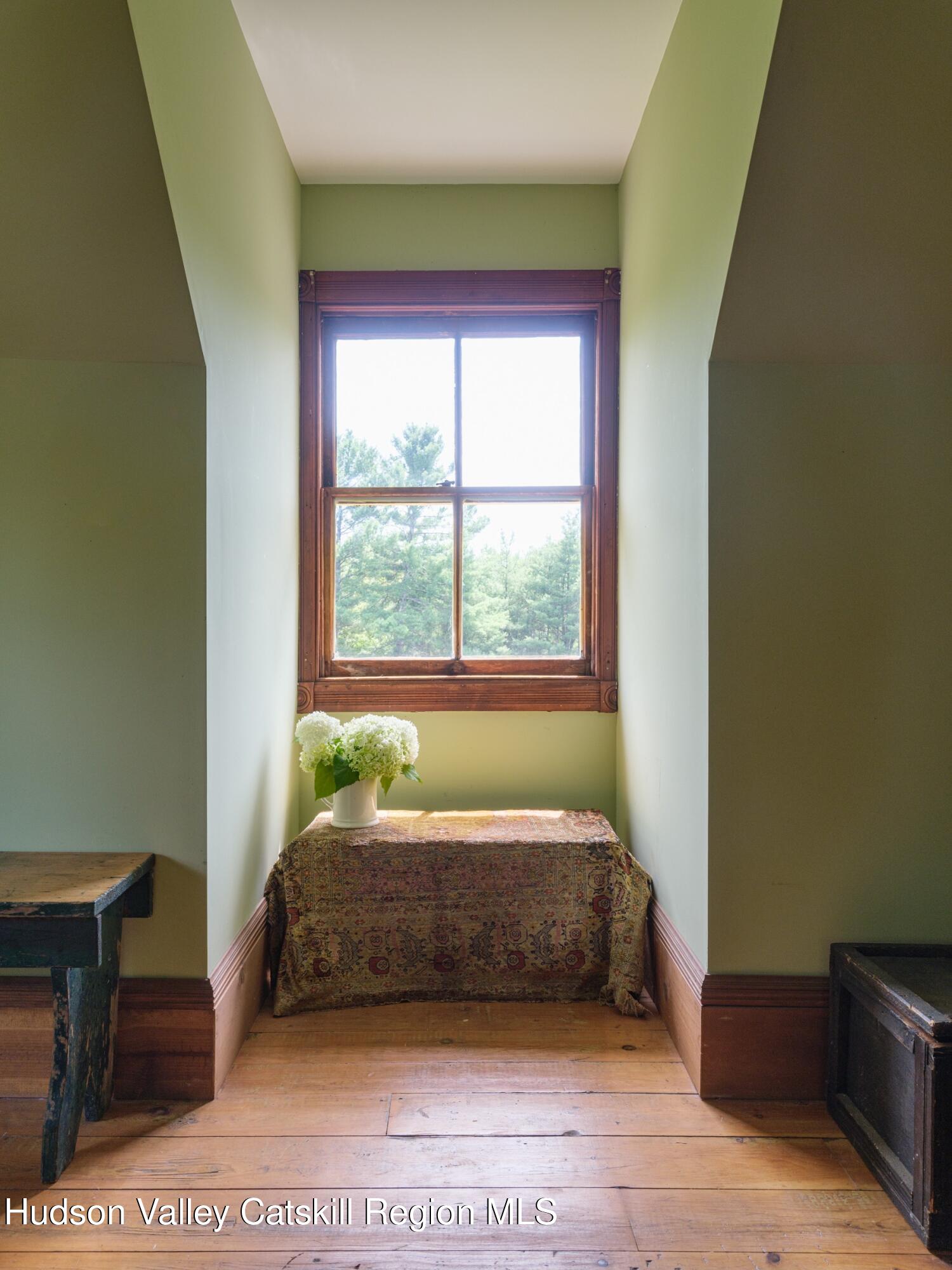 2659 County Rte 9 East Chatham, NY 12060 - Photo 32 of 46 a bed sitting in a bedroom next to a window