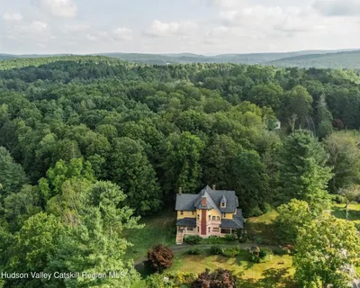 an aerial view of a house with a yard