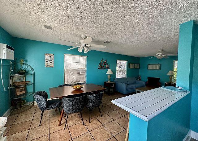 921 Center Street, Unit 12 Key West, FL 33040 - Photo 11 of 22 a room with furniture a window and wooden floor