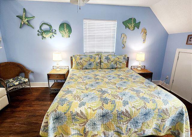 921 Center Street, Unit 12 Key West, FL 33040 - Photo 13 of 22 a bedroom with a bed and wooden floor