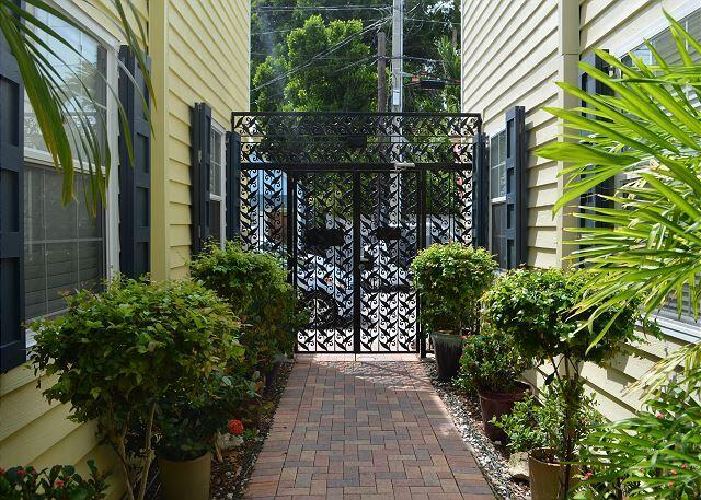 921 Center Street, Unit 12 Key West, FL 33040 - Photo 16 of 22 a view of a pathway that has a flower garden