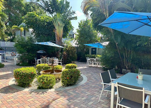 921 Center Street, Unit 12 Key West, FL 33040 - Photo 19 of 22 a view of a chair and tables in the patio