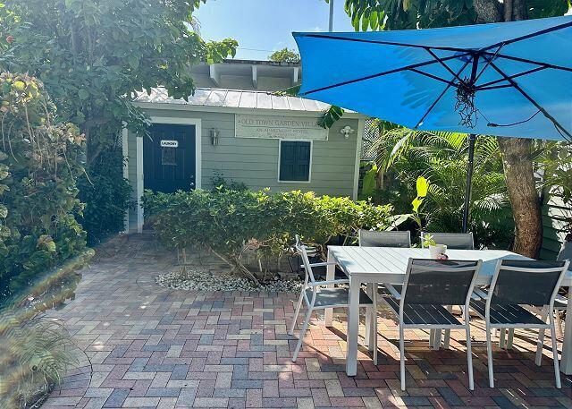 921 Center Street, Unit 12 Key West, FL 33040 - Photo 20 of 22 a view of a patio with table and chairs under an umbrella