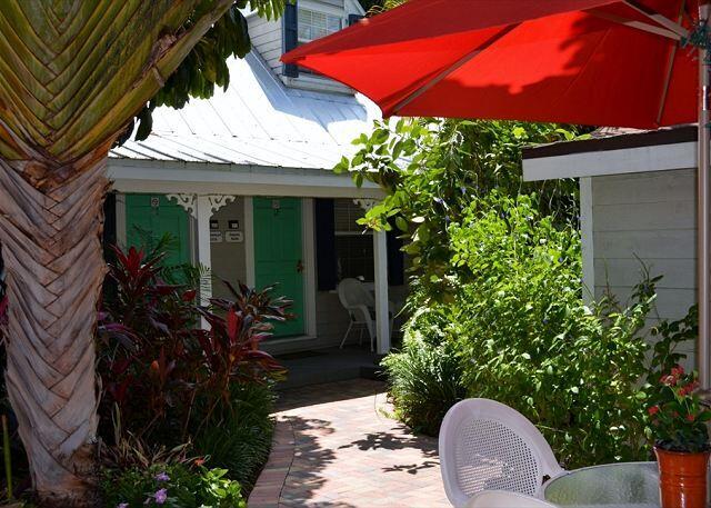 921 Center Street, Unit 12 Key West, FL 33040 - Photo 2 of 22 a view of a patio with table and chairs potted plants