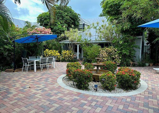 921 Center Street, Unit 12 Key West, FL 33040 - Photo 6 of 22 a view of a chair and tables in the patio