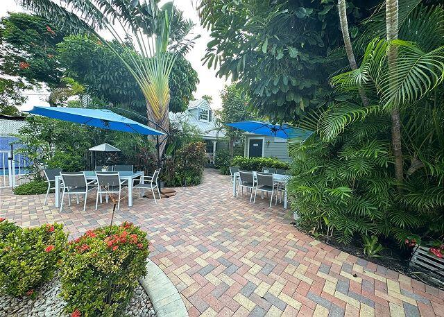 921 Center Street, Unit 12 Key West, FL 33040 - Photo 8 of 22 a view of a patio with table and chairs and potted plants