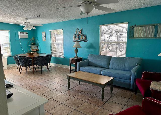 921 Center Street, Unit 12 Key West, FL 33040 - Photo 10 of 22 a living room with furniture a dining table and paintings on the wall