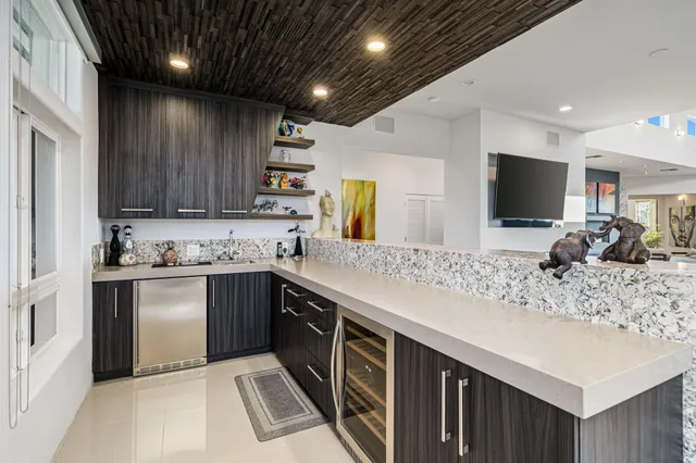 a kitchen with stainless steel appliances granite countertop kitchen island wooden floor and center island