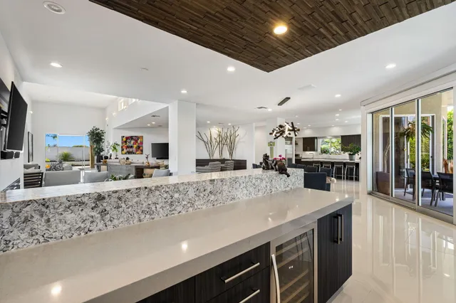 a kitchen with stainless steel appliances granite countertop a sink a stove and a refrigerator