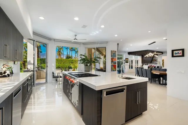 a bedroom with a bed a flat screen tv and a large window with the outer view