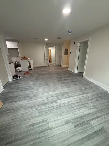 a view of a room with wooden floor